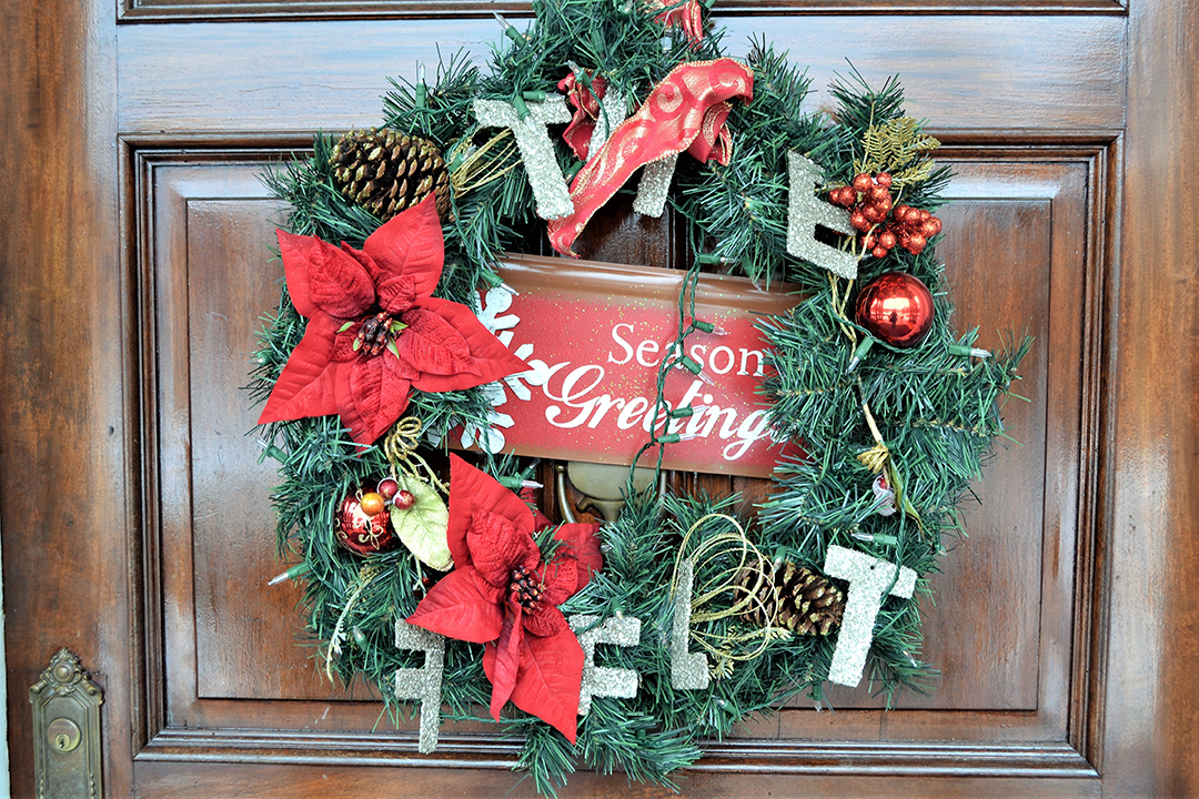 Hang twinkling lights along your porch, wrap garlands around railings, and place potted evergreens or festive planters by your front door.