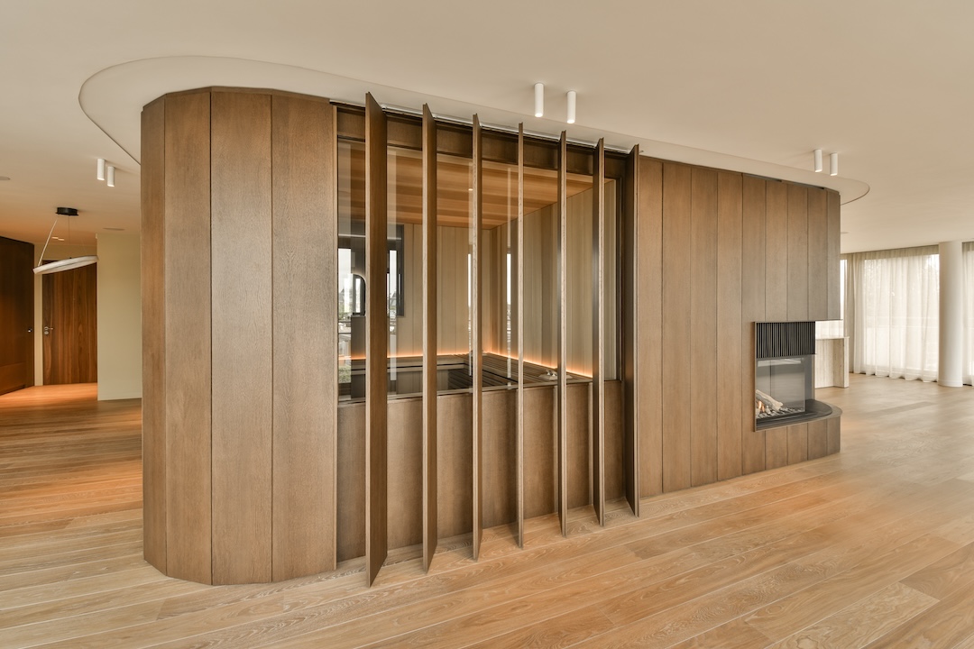 a living room with wooden walls and a fireplace